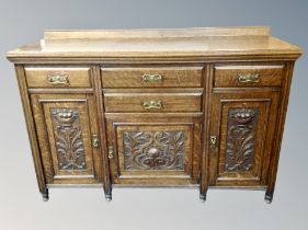 A late Victorian oak Arts and Crafts sideboard,