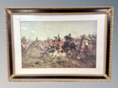 Two decorative gilt-framed prints depicting a 19th century battle scene and a French cafe scene,