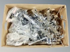 A box of chrome clothes rails and pegs