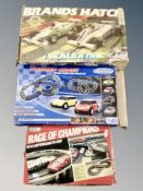 Three boxed racing sets including Scalextric