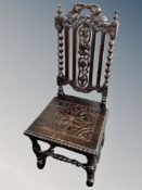 A 19th century heavily carved oak hall chair