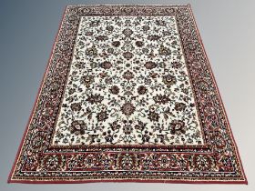 A machine made rug of Persian design,