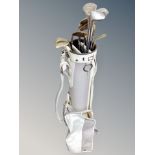 A Slazenger golf bag containing assorted irons and drivers, Wilson etc,