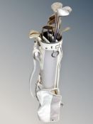 A Slazenger golf bag containing assorted irons and drivers, Wilson etc,