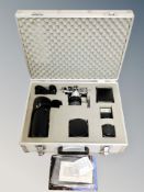 An aluminium camera case containing an Olympus OM2 camera, related accessories, Tamron 58mm lens,