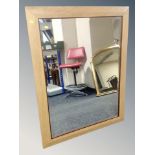 A contemporary oak bevelled mirror,