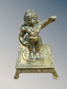 A 19th century Tibetan brass devotional statue, height 9cm.