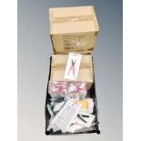 A box of nail care accessories including scissors, LED UV nail lamps,