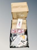 A box of nail care accessories including scissors, LED UV nail lamps,