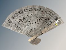 An Oriental oversized carved wooden hand fan,