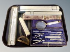 A precision drawing set in fitted case together with a collection of vintage folding rules,