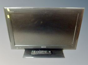 A Sony Bravia 26 inch LCD TV with lead and remote