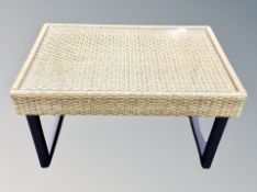 A contemporary wicker glass topped coffee table,