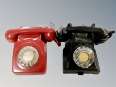 A vintage black Bakelite telephone and further red plastic telephone
