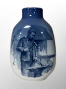 A Royal Copenhagen blue and white porcelain vase depicting a blacksmith,