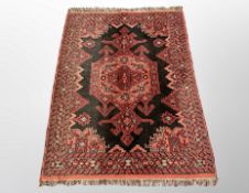 An Iranian rug on red ground 144 cm x 103 cm