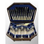 An oak canteen of mixed silver plate and stainless steel cutlery,