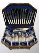 An oak canteen of mixed silver plate and stainless steel cutlery,