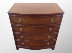 A reproduction mahogany bow fronted four drawer chest,