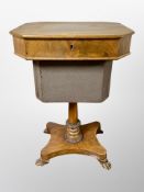 A 19th century walnut pedestal work table on paw feet,