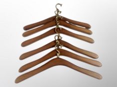 Six 1970's Danish teak and brass coat hangers