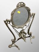 An Art Nouveau style metal framed mirror,
