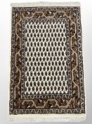 A Tabriz-design rug on beige ground 100 cm x 62 cm