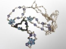 An enamelled silver necklace with glass beads and floral design