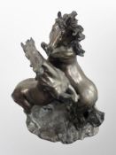 A large resin figure of two rearing horses,