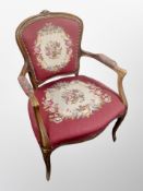 A French carved beech salon armchair in needlework fabric,