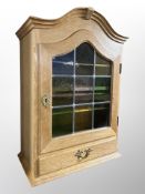 A Danish blond oak leaded glass single door cabinet fitted a drawer,