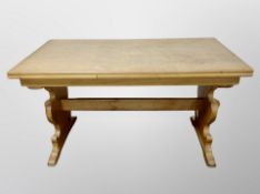 A Danish blond oak pull out refectory dining table and set of four chairs in striped upholstery