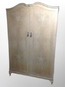 A three piece bleached walnut bedroom suite comprising of double door wardrobe,