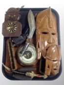 A Kukri knife in sheath, Black Forest style cuckoo clock, carved wooden masks,