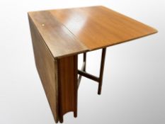 A 1970's G-Plan teak drop leaf dining table,