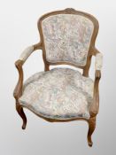 A French carved beech salon armchair,