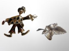 A silver maple leaf brooch and an articulated clown brooch
