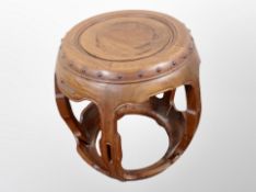 A Chinese carved hardwood barrel shaped plant stand,