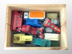 A pine crate and further basket containing playworn die cast vehicles, DInky,