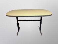 A 1970's chrome and melamine oval dining table,