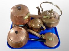 A group of copper kitchenalia including teak-handled pan on burner, further long-handled pan,