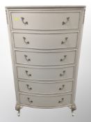 A cream and gilt six drawer chest,