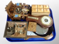 A Continental cuckoo clock with weights together with a two barometers, small wooden spice rack,