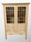 A blond oak Danish leaded glass door cabinet,