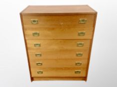 A 1970's Danish teak and pine six drawer chest with brass drop handles,