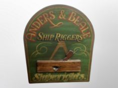A painted wooden panel with ship rigger's decoration,