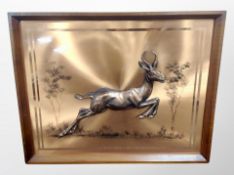 A 1970's copper-effect wall panel depicting a running antelope,