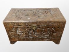 An Oriental heavily carved camphor wood blanket chest,