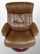 A late 20th century Danish brown leather swivel armchair