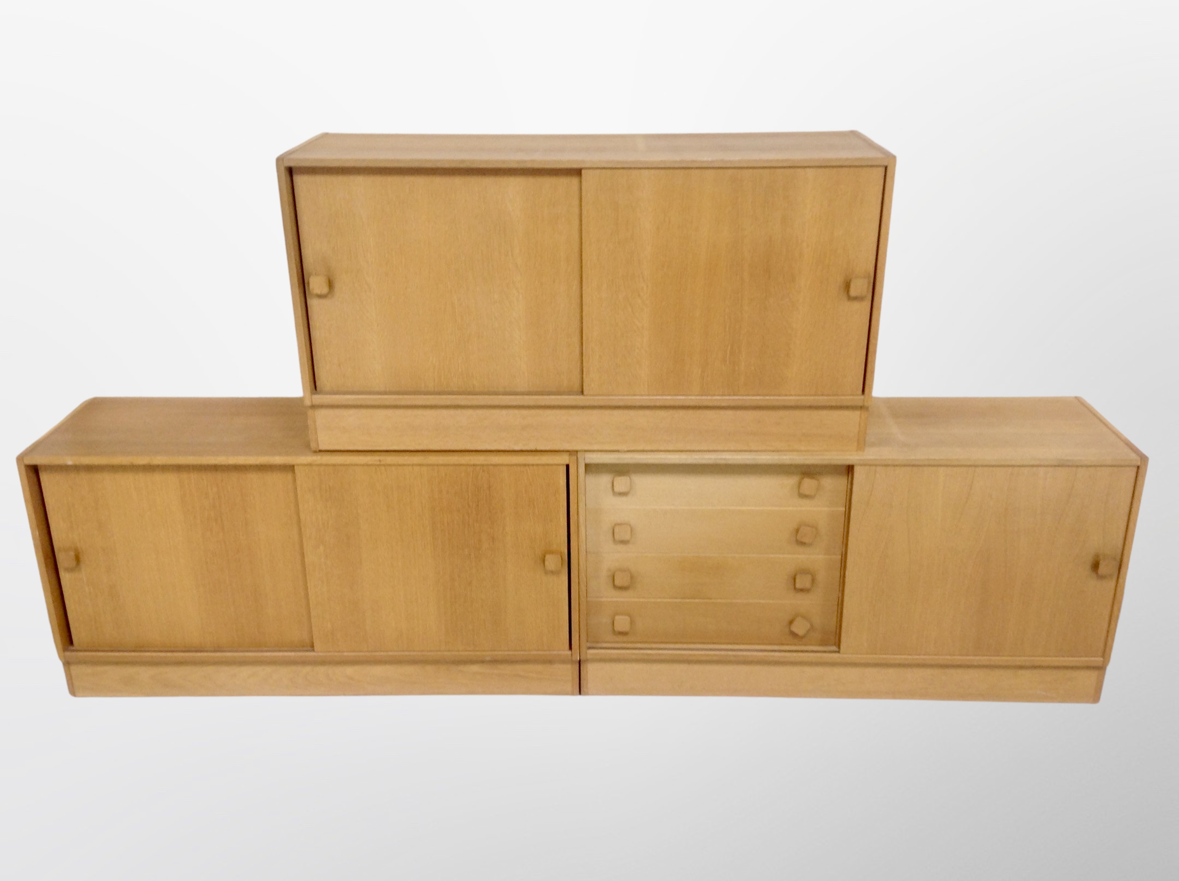 Three 20th century Danish oak effect sliding door low sideboards,